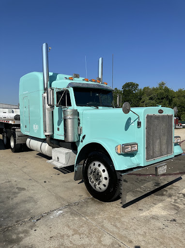 Light teal Bilbo Peterbilt tractor with tall chrome stacks